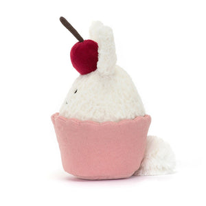 Peek-a-boo! See the fluffy tail of a playful bunny hiding inside a pink cord "cake." Discover the Jellycat Dainty Dessert Bunny Cupcake, a unique and cuddly friend.