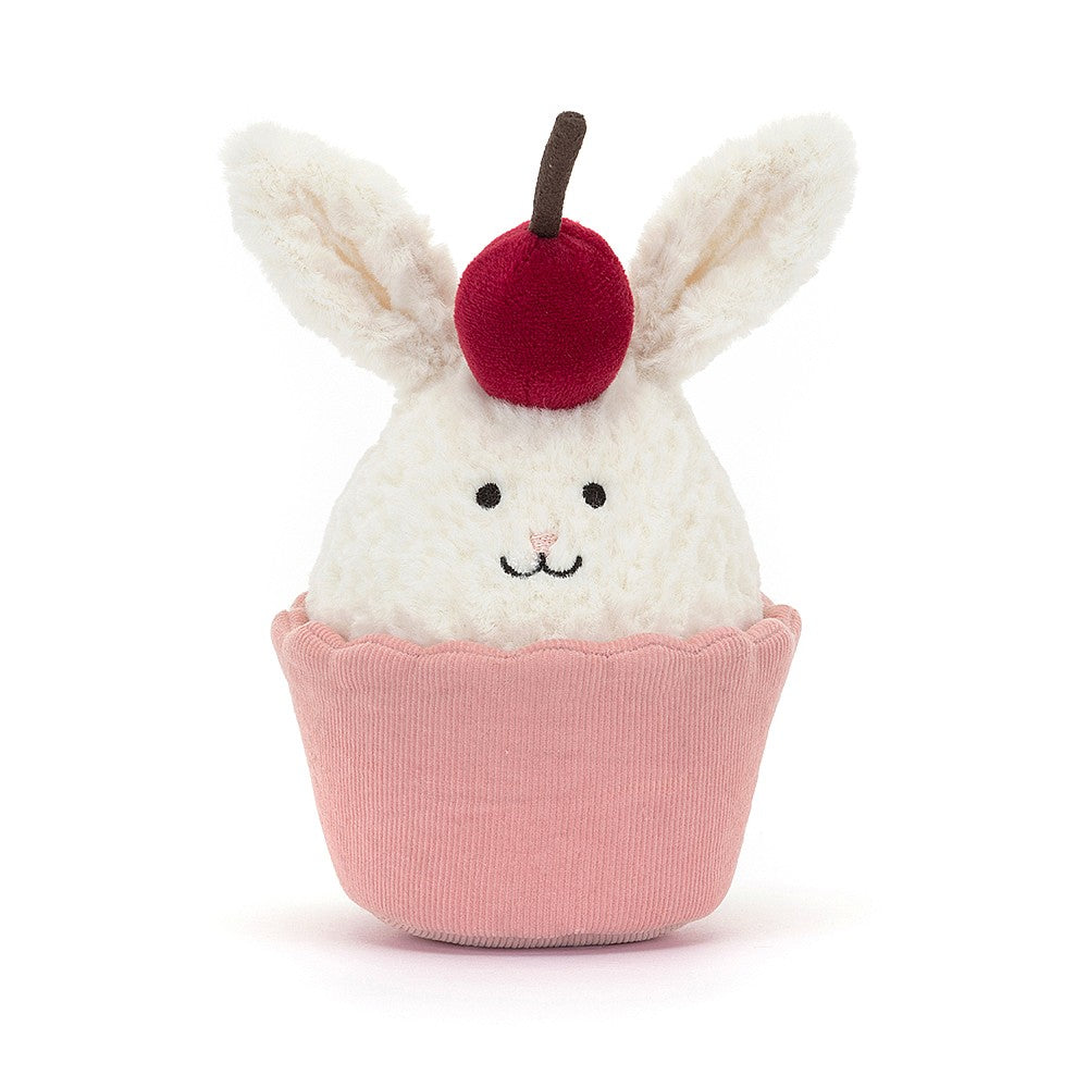 Sweet dreams are made of this! Adorable Jellycat Dainty Dessert Bunny Cupcake with soft cream fur, perky ears, and a bright cherry hat. Snuggle-worthy gift for all ages.