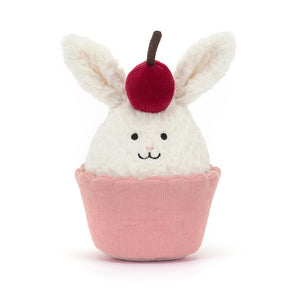 Sweet dreams are made of this! Adorable Jellycat Dainty Dessert Bunny Cupcake with soft cream fur, perky ears, and a bright cherry hat. Snuggle-worthy gift for all ages.