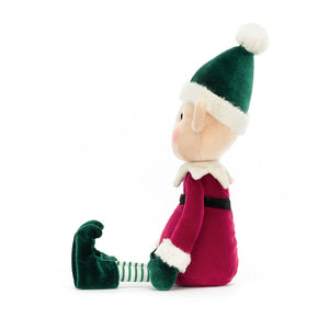 Jellycat Eldo Elf in profile, highlighting his curly velvet boots and ivy green bobble hat.

