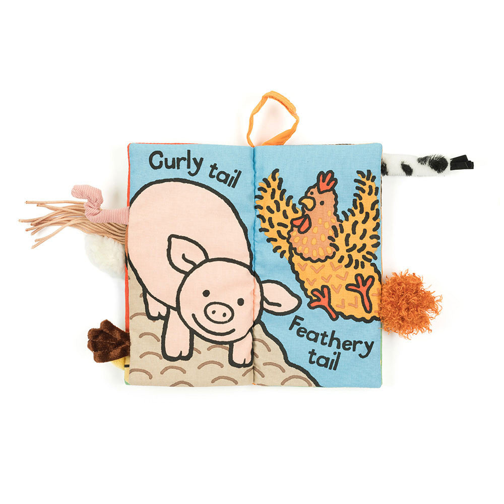 Open spread of Jellycat Farm Tails book with pig and chicken illustrations and textured tails.