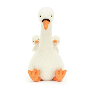 Image of Jellycat Featherful Swan, a luxuriously soft, plush swan with creamy white fur and bright orange accents. The swan has suedette feet and beak, and piping details. Two tiny cygnets are nestled within the swan's wings.