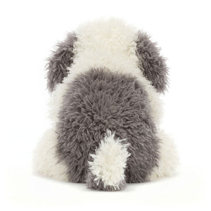 Rear view of Jellycat Floofie Sheepdog, highlighting its fluffy grey and cream coat, floppy ears, and wagging tail.