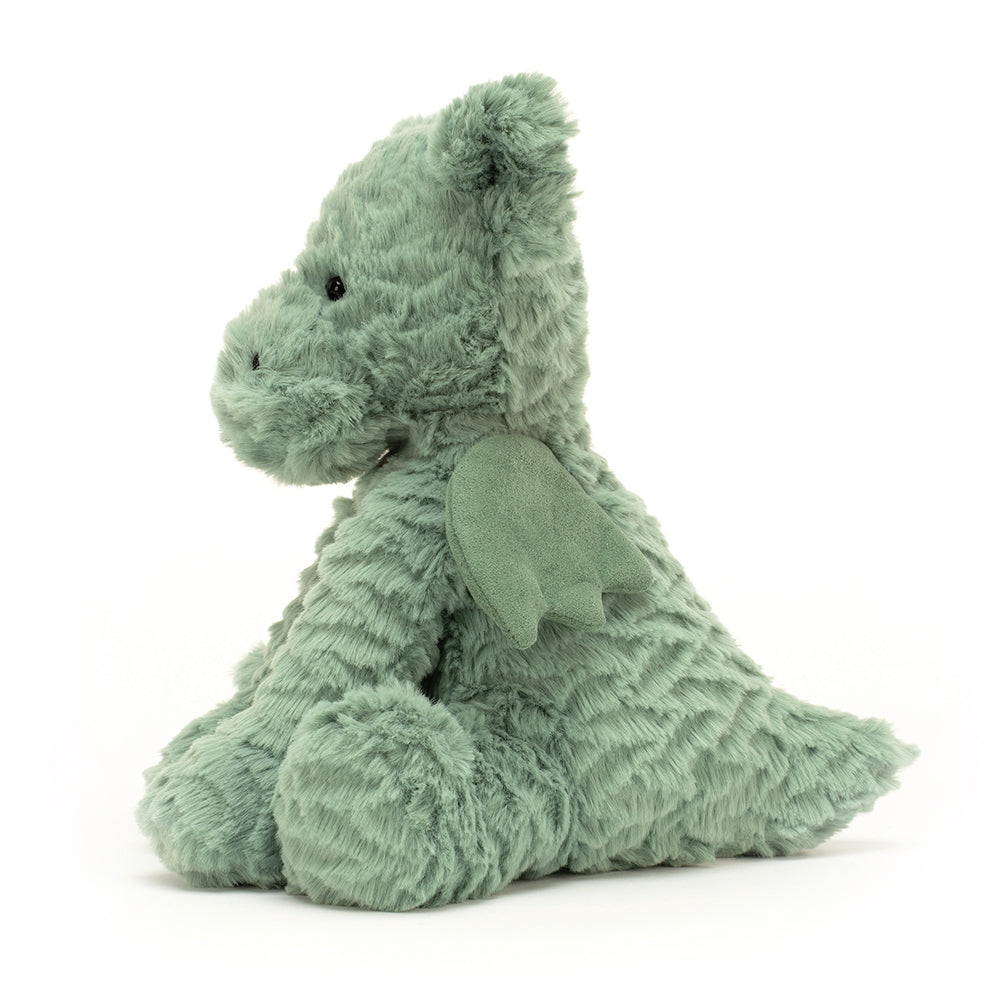 Side: This adorable Jellycat Fuddlewuddle Dragon shows off its minty green fur, endearing side profile, and soft suedey wings tucked against its back.