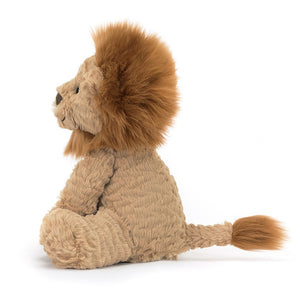 Side: This adorable Jellycat Fuddlewuddle Lion shows off its luxuriously soft ginger fur, endearing side profile with floppy ears, and a cute, curly tail.
