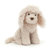 Front: A luxuriously soft Jellycat Georgiana Poodle with a curious expression, stitched eyes, and delightfully messy champagne-colored fur. Her long, scruffy ears flop down and her tail curves playfully.