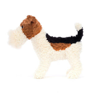 Side: This energetic Jellycat Hector Fox Terrier shows off his charming side profile. His soft fur is a delightful mix of cream, brown, and ginger, and his wagging tail hints at his playful personality.