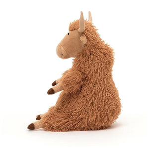 Side: Herbie the Highland Cow, a cuddly Jellycat plush with a luxuriously shaggy coat in a butterscotch hue. He has floppy petal-fold ears and a charming two-tone nose.