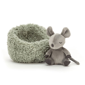 Adorable Jellycat Hibernating Mouse plush toy sitting outside his mossy bed.