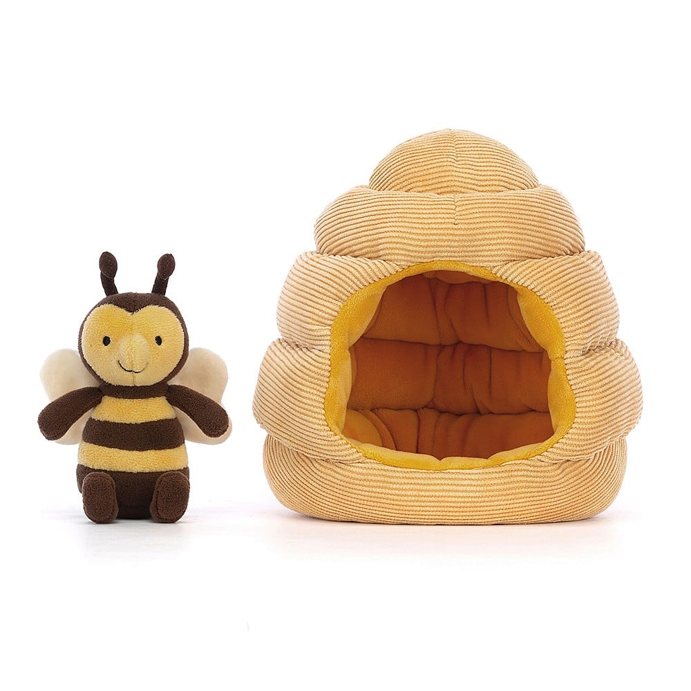 Super-soft cuddles guaranteed! This frontal view of Jellycat  Honeyhome Bee highlights its adorable face, bobbly feelers, Honeyhome Bee is standing outside a cozy hive.