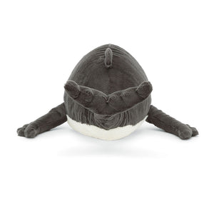 A rear view of Jellycat Humphrey the Humpback Whale, showing his plush grey body, raised tail, and flippers extending outward in a playful swimming pose.