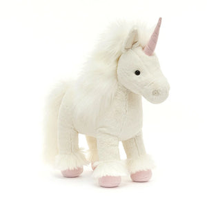 Angled View: Jellycat Isadora Unicorn playfully ajar, showcasing its flowing clotted-cream fur, magnificent plume mane and tail, and a touch of the silky feather hidden within. The pink twist horn with silver stitching adds a touch of magic.