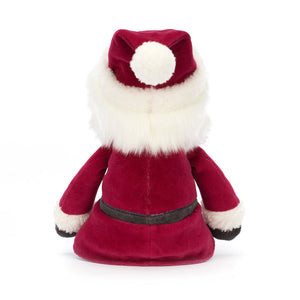 Behind: Cuddly Jellycat Jolly Santa plush (back view): Santa with red coat and bobble hat.