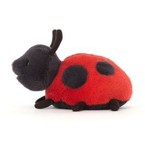 Side profile of the Jellycat Layla Ladybird plush toy, showcasing its detailed legs and suedey feelers.







