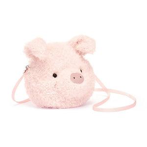 Jellycat Little Pig Bag, a small, plushbag shaped like a pigs head with soft pink fur and an embroidered snout. The bag has adjustable straps and a spacious interior compartment.