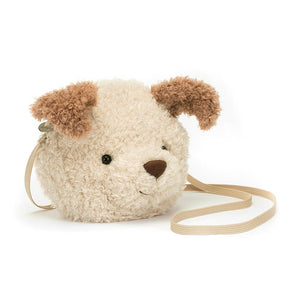 Jellycat Little Pup Bag, a small, cream and toffee plush bag shaped like a dogs head with soft fur, floppy ears, and a playful expression. The bag has adjustable straps and enough space for essentials like a phone, wallet, and keys.