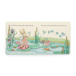 Inside pages of Jellycat Lottie The Fairy Bunny Book, showing Lottie the fairy bunny standing on a lily pad with dragonflies, fish, and birds in a whimsical pond setting.