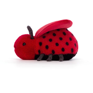 Side View: Jellycat Loulou Love Bug, soft red fur bug with heart-shaped wings and sparkly legs and feelers.