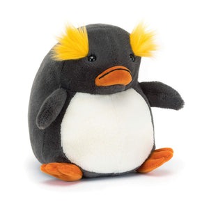 Jellycat Maurice Macaroni Penguin plush with yellow eyebrows and orange beak, sitting upright.