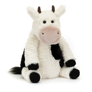 Front view of Jellycat Mooliet Cow, a plush toy with black-and-white fur and a pink snout.