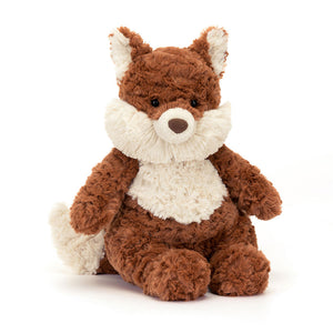 Angled View: Looking for a cuddle? The Jellycat Mortimer Fox leans forward, showcasing his signature messy red fur, adorable tufty cream cheeks, and a chunky tail perfect for holding. Two-toned ears and a cute brown nose add to his charm. 