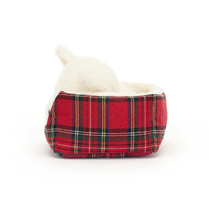 Side View: Jellycat Napping Nipper Westie. The side profile reveals the depth of the plush, the softness of the fur, and the tartan pattern of the bed.