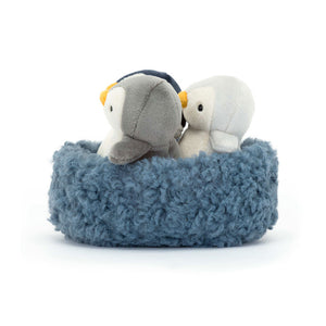 Side View: Peek-a-boo penguins! The Jellycat Nesting Penguins with removable friends in navy, grey, and silver fur.