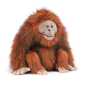 Angled view: Calling all explorers! Oswald Orangutan by Jellycat is ready for adventure. This shaggy orangutan features soft fur, a wise face, and long arms for big hugs.