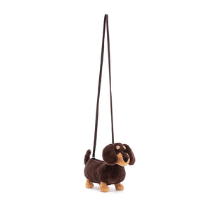 Angled view: Jellycat Otto Sausage Dog Bag highlighting the lengthy strap.