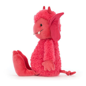 Side view: Watch out for pixie dust! This cuddly Jellycat pixie, Pandora, features soft Strawberry red fur, a curly tail, and funky cream fangs for playful pranks.