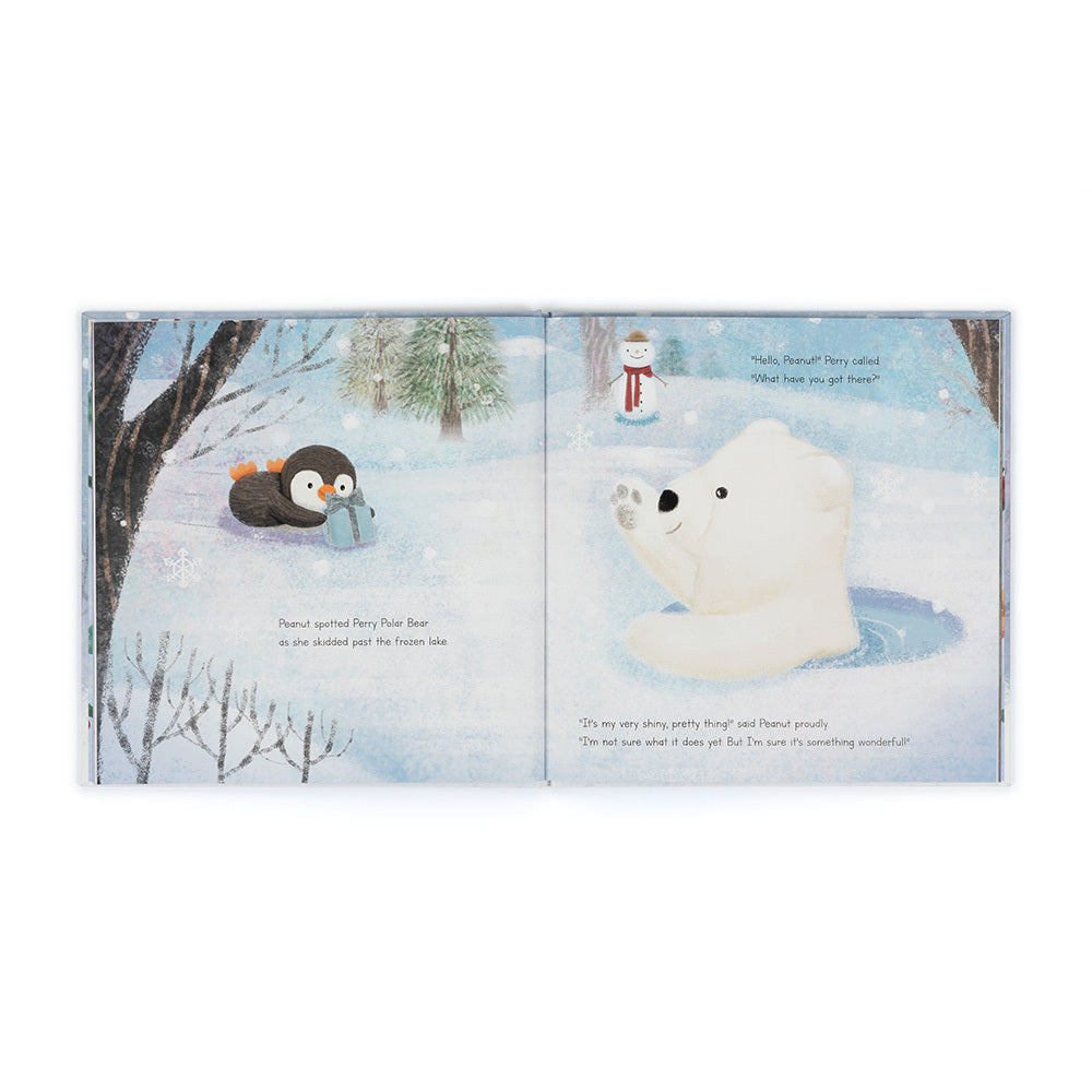 Open pages of Peanut Penguin’s Perfect Present showing Peanut sliding across a frozen lake with a polar bear illustration.