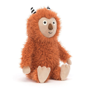  Pip Monster, a cuddly Jellycat plush with tousled ginger fur, peeks out from behind his giant suedey truffle nose, ready for mischievous adventures.Angled View: 