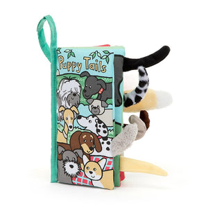 Jellycat Puppy Tails Activity Book standing upright, highlighting its compact size (22 cm x 13 cm), ideal for little hands to grasp. The thickness hints at engaging textures and colorful pages within.