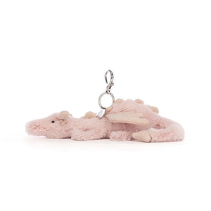 Side view of Jellycat Rose Dragon Bag Charm, showcasing its detailed spines, textured wings, and curved shape.