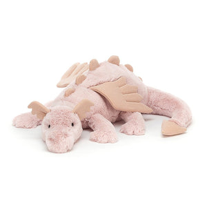 Angled View: Sparkly Rose Dragon by Jellycat, curled slightly, with soft pink fur, rose-gold wings, and a sleepy expression.