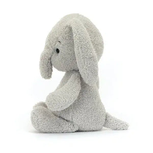 Side view of Jellycat Rumblikin Elly showing floppy ears, a tufted tail, and huggable shape.