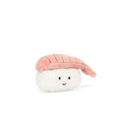 Angled view: Jellycat Sassy Sushi Nigiri makes a statement! This soft plush sushi features a pink shrimp hat with stitched details, perched on a bed of fluffy rice. 