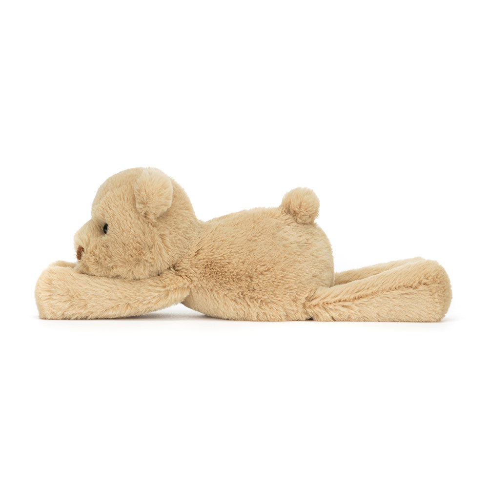 Side view of Jellycat Smudge Bear Tiny lying down, showing its floppy design and plush body.