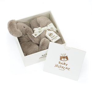 The Jellycat Smudge Elephant Soother features a soft elephant with big ears, holding a soother. Presented in a beautiful Jellycat gift box.