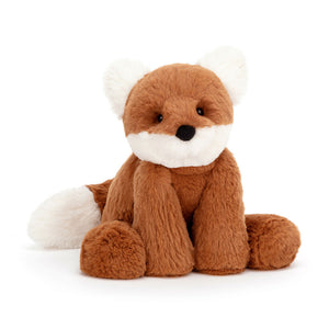 Jellycat Smudge Fox facing front, highlighting its adorable expression, soft dark orange fur with contrasting fluffy cream ears and muzzle, and a chunky cream-tipped tail.