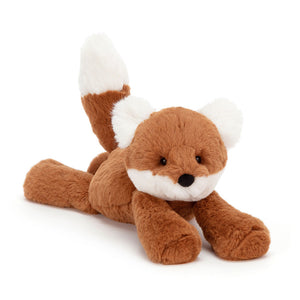 Jellycat Smudge Fox stretched out  , showcasing its super soft dark orange fur, fluffy cream ears and muzzle, chunky cream-tipped tail, and playful "trumpet legs."