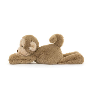 Side view of the Jellycat Smudge Monkey soft toy showcasing its floppy arms and tail.