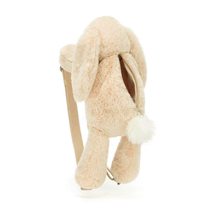 Adorable Jellycat Smudge Rabbit Backpack from behind. Features include soft oatmeal fur, a cute snowy bobtail, a secure silver zipper with Jellycat tag, and adjustable beige straps.