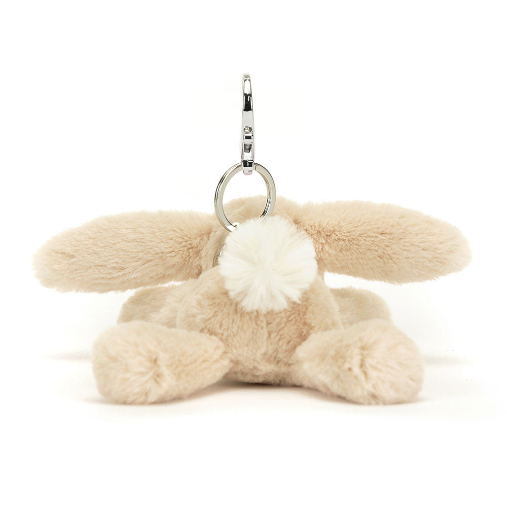 Back view of Jellycat Smudge Rabbit Bag Charm, showcasing its soft beige fur and silver claw clip attachment for easy bag attachment.