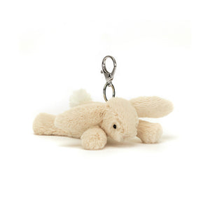  Jellycat Smudge Rabbit Bag Charm tilted slightly, showcasing its soft beige fur, floppy ears, fluffy pompom tail, and gentle stitch face.