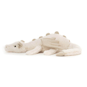 Side View: A side view of a cuddly snow dragon toy, showcasing its three-dimensional shape, long tail, and delicate wings.