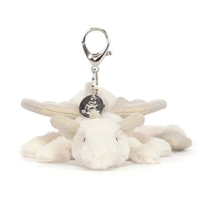 A close-up of the Jellycat Snow Dragon Bag Charm, showcasing its soft fur, sparkling details and silver clip and charm.