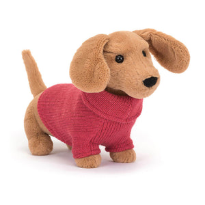 Front view of Jellycat Sweater Sausage Dog Pink plush toy wearing a pastel pink sweater and floppy ears.