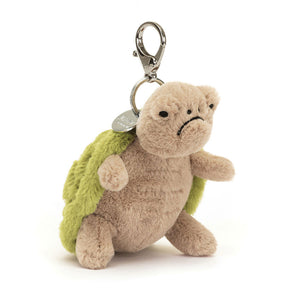 Angled View: A little grump goes a long way! The Jellycat Timmy Turtle Bag Charm leans in, showcasing its textured beige tummy and embroidered green shell with a grumpy pout. A silver claw clip lets Timmy hang on for adventures, big or small. Perfect for grumpy glam on any bag! 