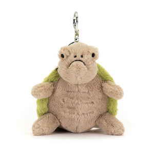 Straight On View: Front view of the Jellycat Timmy Turtle Bag Charm. Features a luxuriously soft beige tummy with a detailed green embroidered shell and a grumpy expression. A silver claw clip securely attaches Timmy to your bag. This charming (despite the grump!) turtle adds a touch of personality to any outfit!